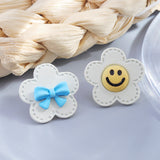 S925 silver needle white flower bow smiley earrings