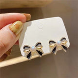 Delicate and small pearl black bow earrings