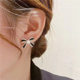 Delicate and small pearl black bow earrings