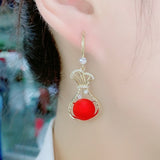 Red purse pearl earrings